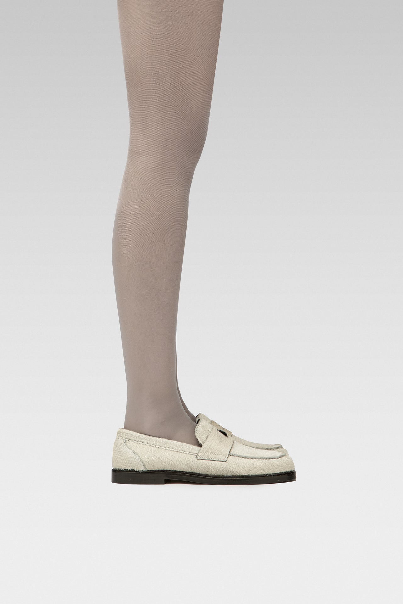 EDLA Galaxy Grey tights Crafted from a silky 20 denier finish, the Galaxy Tights feature a sheer body, shaped silhouette, and invisible toe together with EDLA Jupiter White loafers Crafted from soft calf hair, the Jupiter Loafer features a rounded toe and a cut-out band with moon and star details.