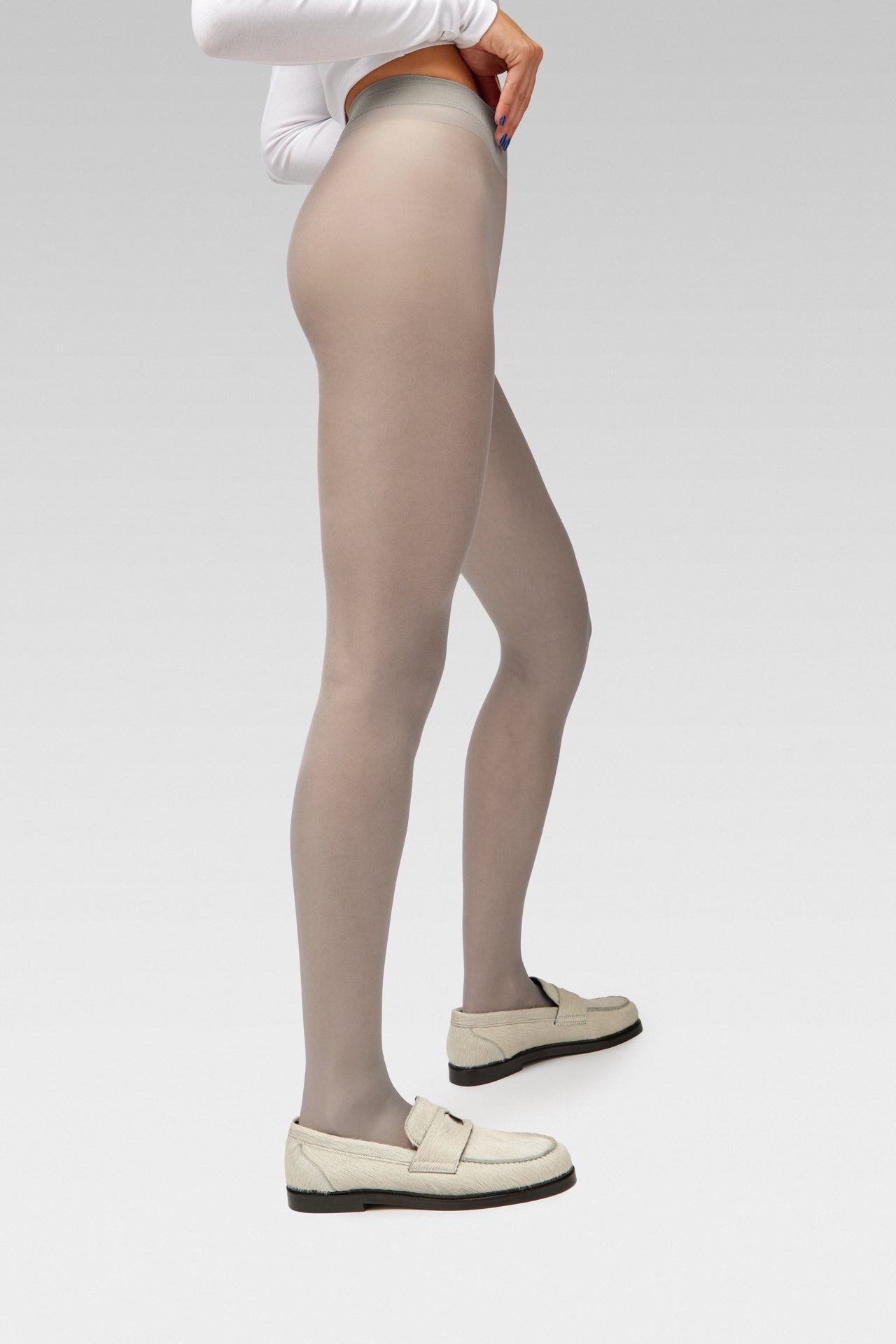 EDLA Galaxy Grey tights Crafted from a silky 20 denier finish, the Galaxy Tights feature a sheer body, shaped silhouette, and invisible toe together with EDLA Jupiter White loafers Crafted from soft calf hair, the Jupiter Loafer features a rounded toe and a cut-out band with moon and star details.
