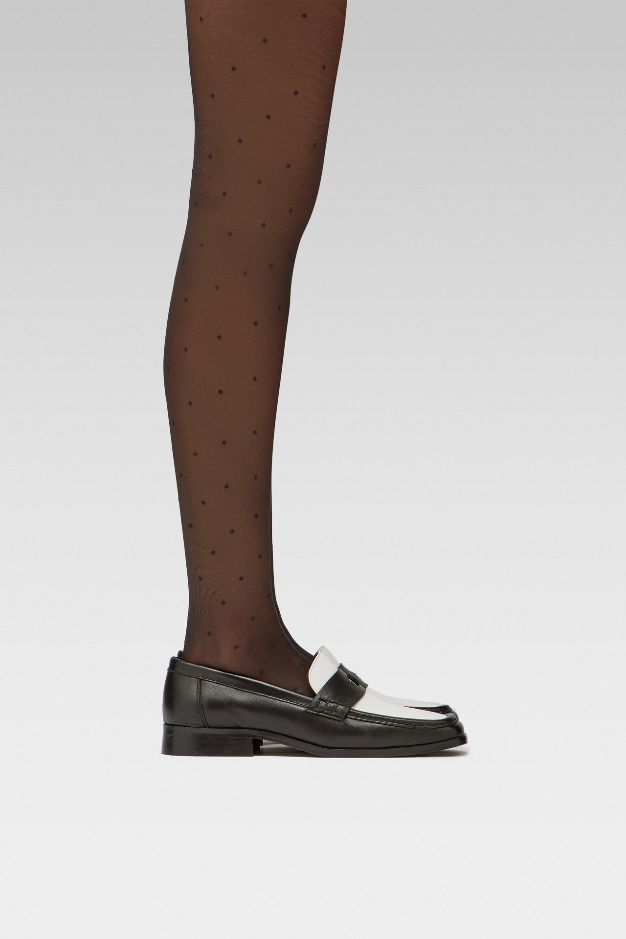 EDLA Orbit Black Polka Dots tights Crafted from a 20 denier eco-friendly yarn, the Orbit Tights feature an all-over polka dot pattern, a sheer body, and a bikini brief cut with EDLA black and white Earth loafer.