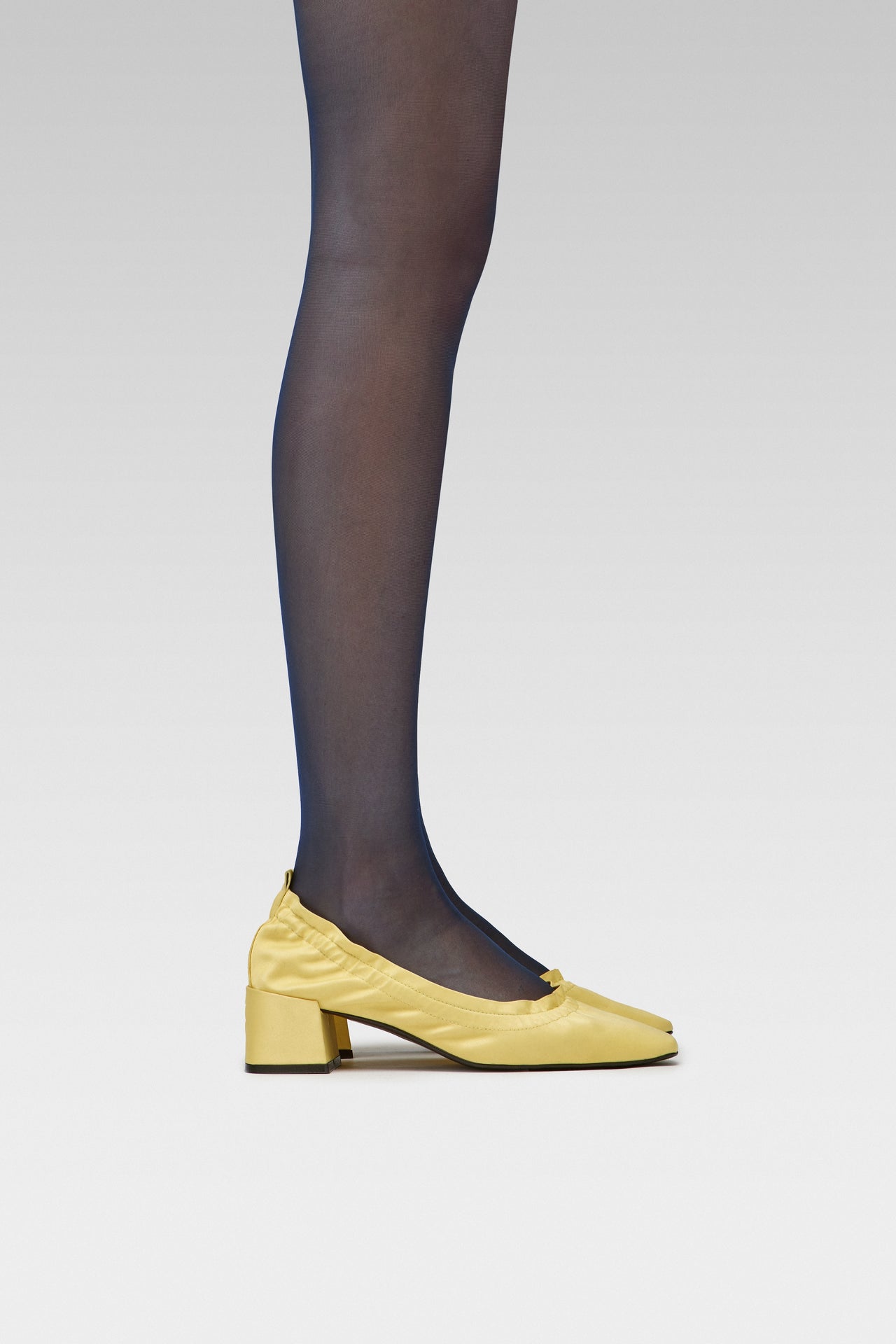 EDLA Galaxy Navy tights with EDLA Yellow Mercury Kitten Heel Crafted in satin, the Mercury Kitten Heel features a ruched edge, squared toe, and a 5cm block heel.