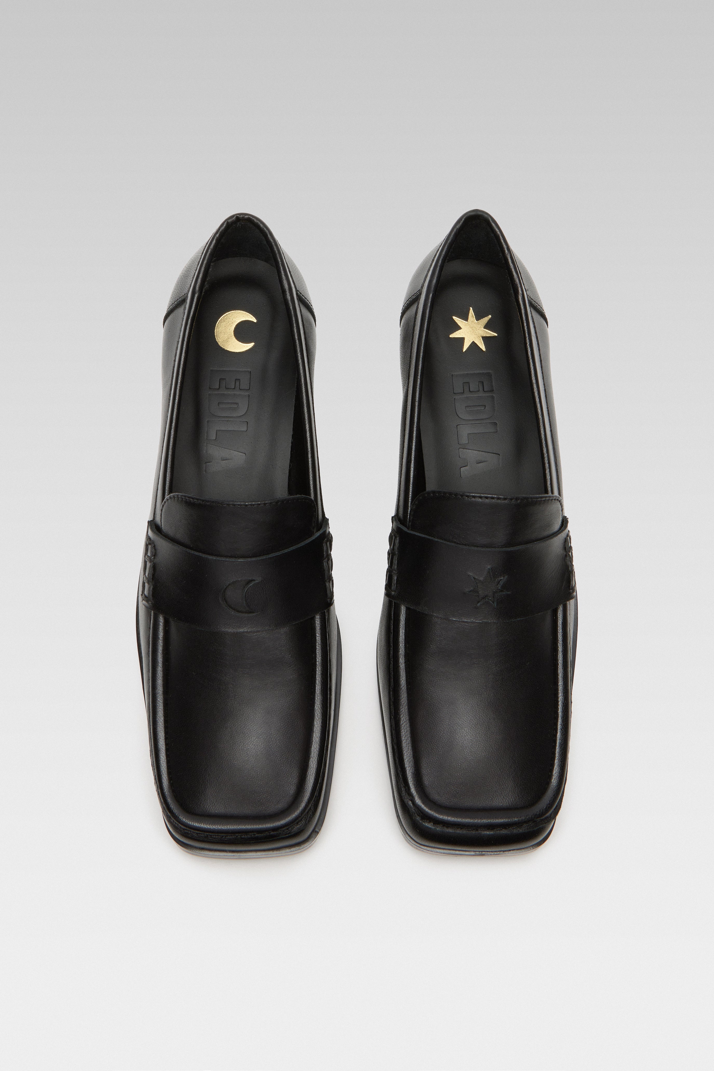 Top view of EDLA Earth black loafers for women crafted from leather with a square toe and star and moon inserts at the front.