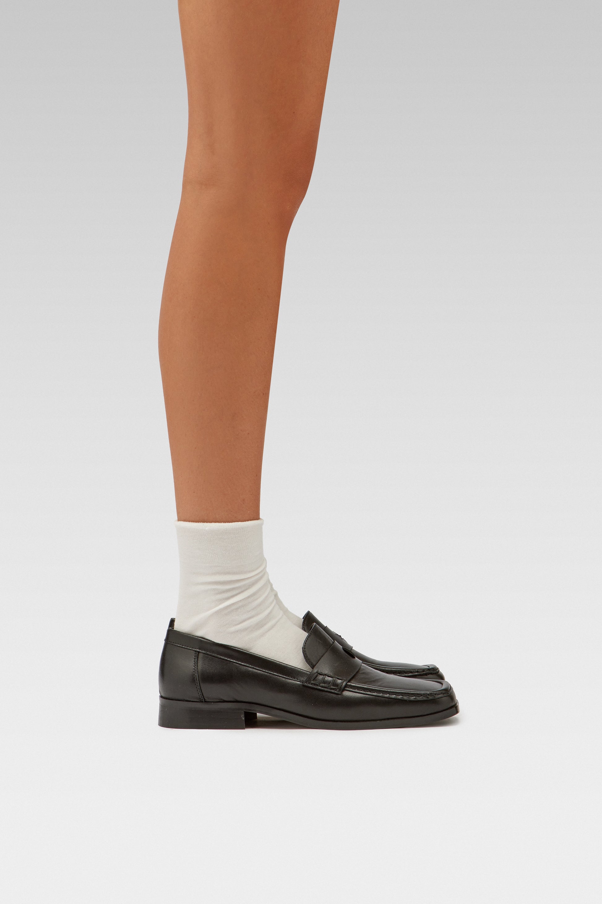 EDLA Ursa white socks with EDLA black Earth loafer for women crafted from soft nappa lambskin, the Earth Loafer features a squared toe and a cut-out band with moon and star details. 