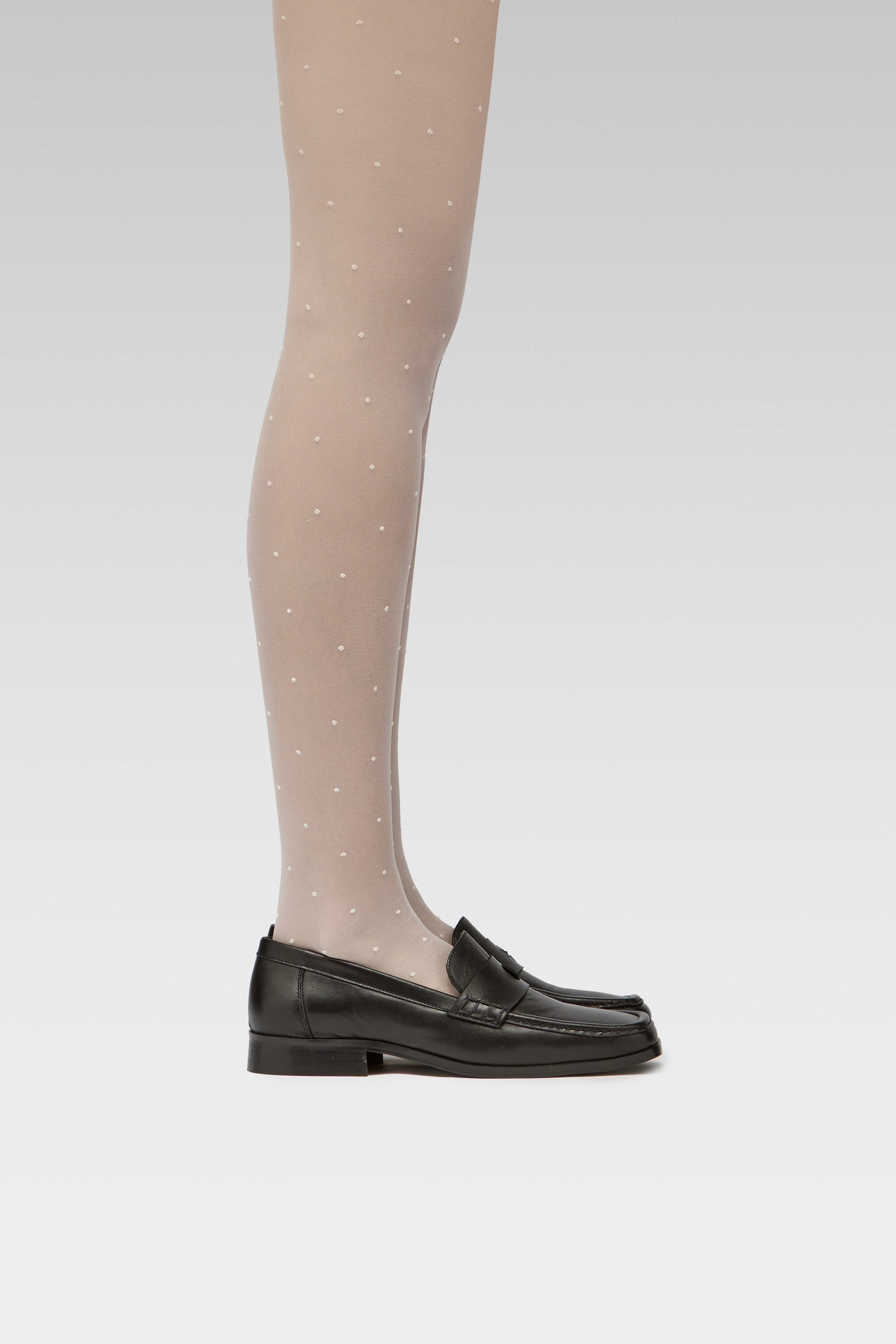 EDLA Orbit White Polka Dots tights Crafted from a 20 denier eco-friendly yarn, the Orbit Tights feature an all-over polka dot pattern, a sheer body, and a bikini brief cut with EDLA black Earth loafer Crafted from soft nappa lambskin, the Earth Loafer features a squared toe and a cut-out band with moon and star details. 