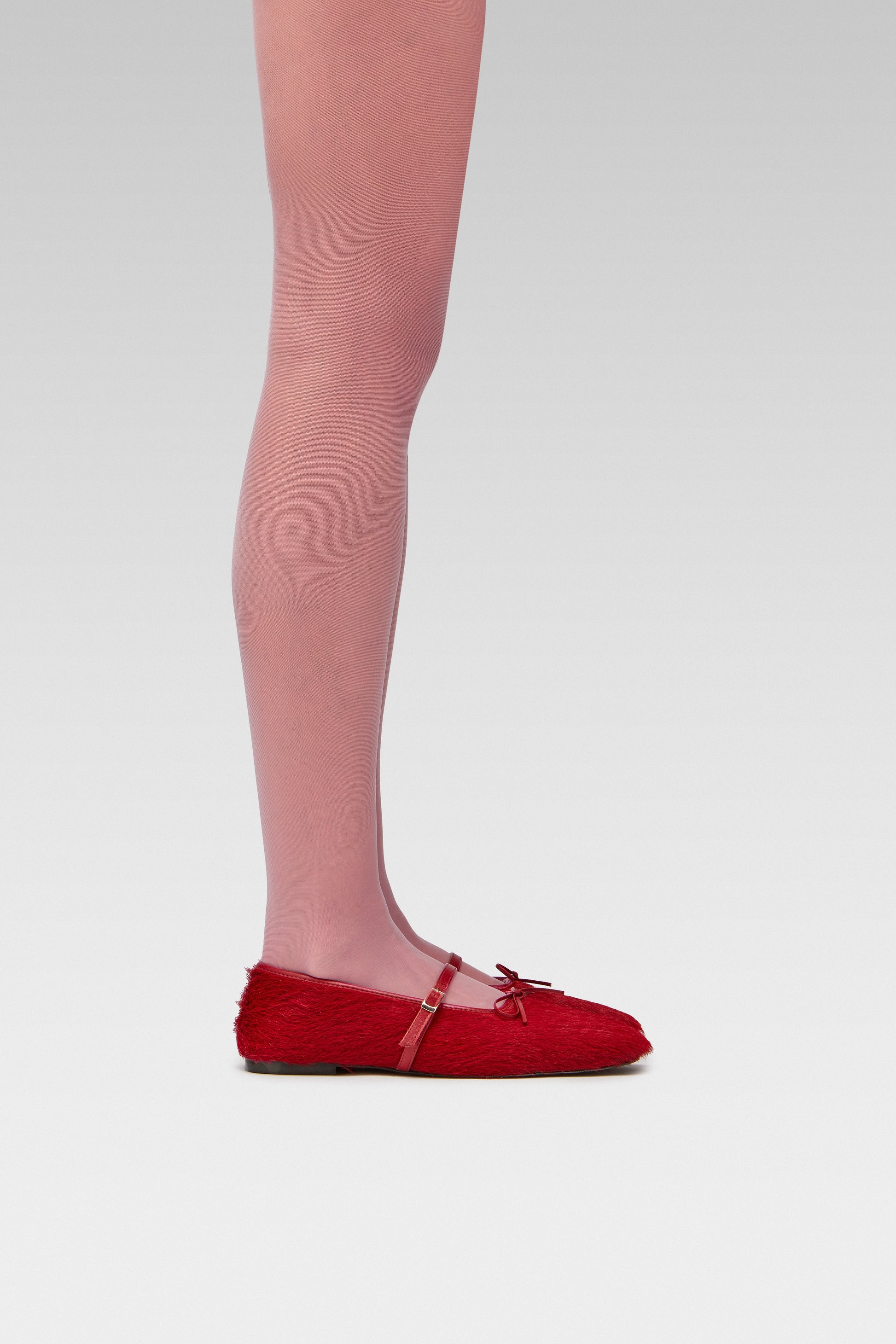 EDLA Galaxy pink tights crafted from a silky 20 denier finish, the Galaxy Tights feature a sheer body, shaped silhouette, and invisible toe with EDLA Mars ballet flat  Crafted from hair calf, the Mars Ballet Flat features a front strap, bow detail, and a squared toe. 