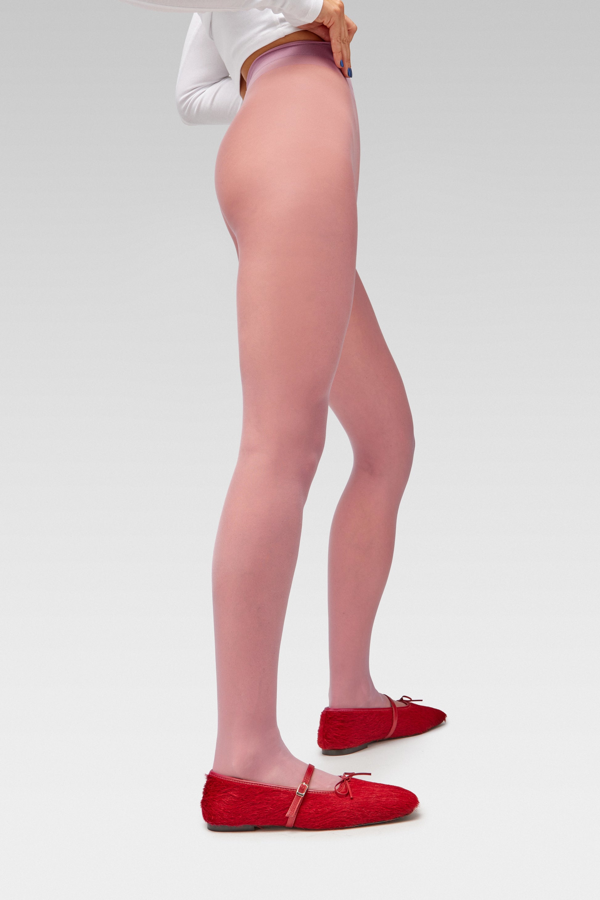 EDLA Galaxy pink tights crafted from a silky 20 denier finish, the Galaxy Tights feature a sheer body, shaped silhouette, and invisible toe with EDLA Mars ballet flat  Crafted from hair calf, the Mars Ballet Flat features a front strap, bow detail, and a squared toe. 