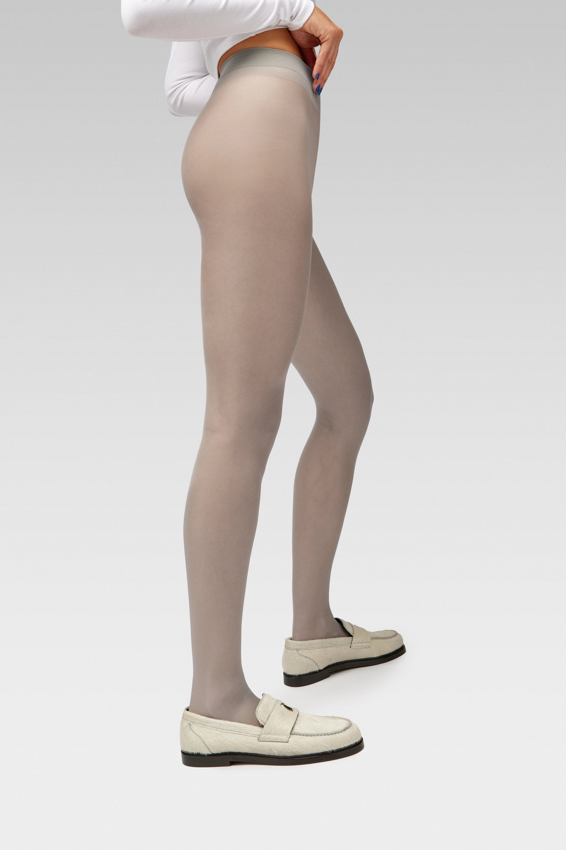 EDLA Galaxy Grey tights Crafted from a silky 20 denier finish, the Galaxy Tights feature a sheer body, shaped silhouette, and invisible toe together with EDLA Jupiter White loafers Crafted from soft calf hair, the Jupiter Loafer features a rounded toe and a cut-out band with moon and star details.