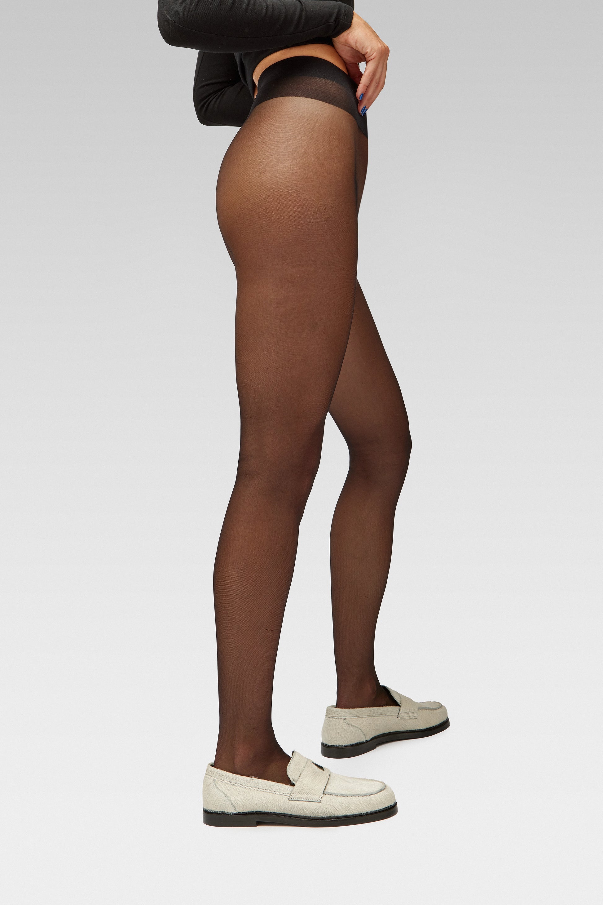 EDLA Eclipse tights Crafted from a silky 15 denier finish, the Eclipse Tights feature a double-covered yarn, sheer body, shaped silhouette, and reinforced toe with EDLA Jupiter white loafer Crafted from soft calf hair, the Jupiter Loafer features a rounded toe and a cut-out band with moon and star details.