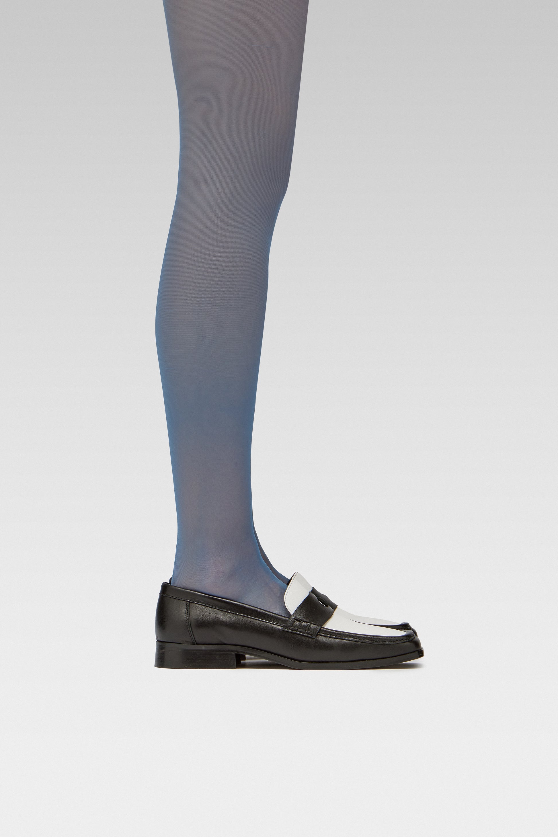EDLA Galaxy Blue tights Crafted from a silky 20 denier finish, the Galaxy Tights feature a sheer body, shaped silhouette, and invisible toe with EDLA black and white Earth loafer.