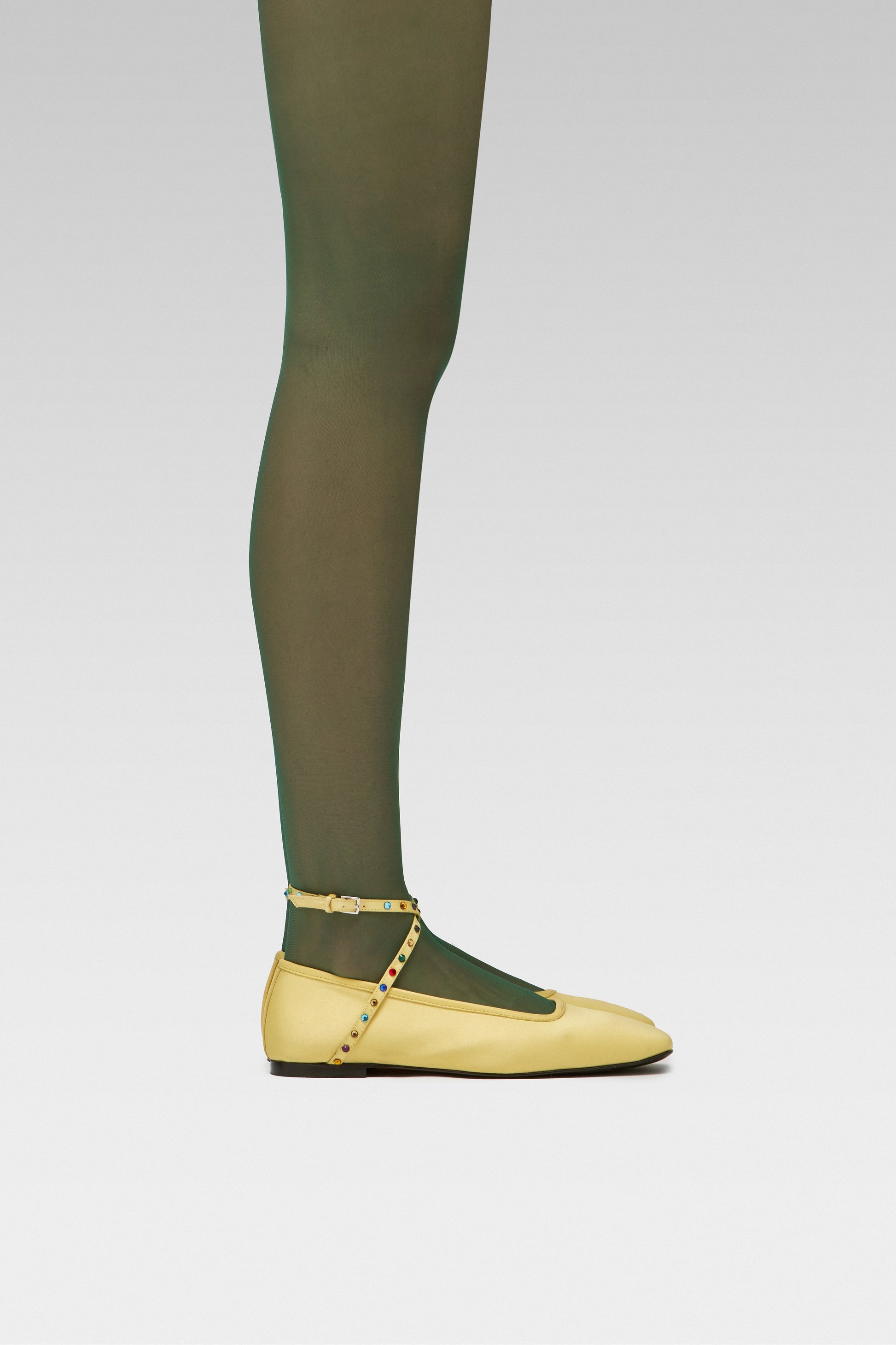 EDLA Galaxy green tights with EDLA Yellow Saturn ballet flats Crafted from butter yellow satin, the Saturn Ballet Flat features multicolored crystal-embellished straps and a squared toe.