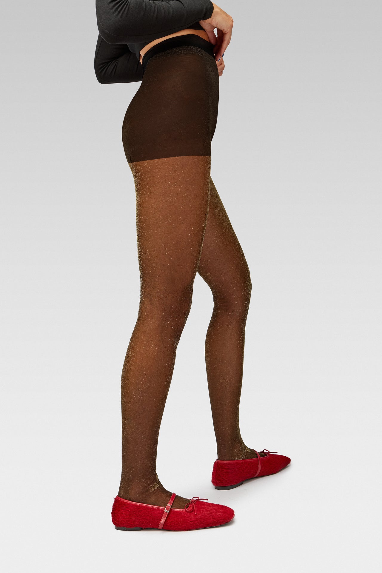 EDLA Cosmic Lurex Tights Crafted from a 40 denier finish with metallised fibre, the Cosmic Gold Lurex Tights feature a subtle shimmer with EDLA Mars Ballet red Flat Crafted from hair calf, the Mars Ballet Flat features a front strap, bow detail, and a squared toe.