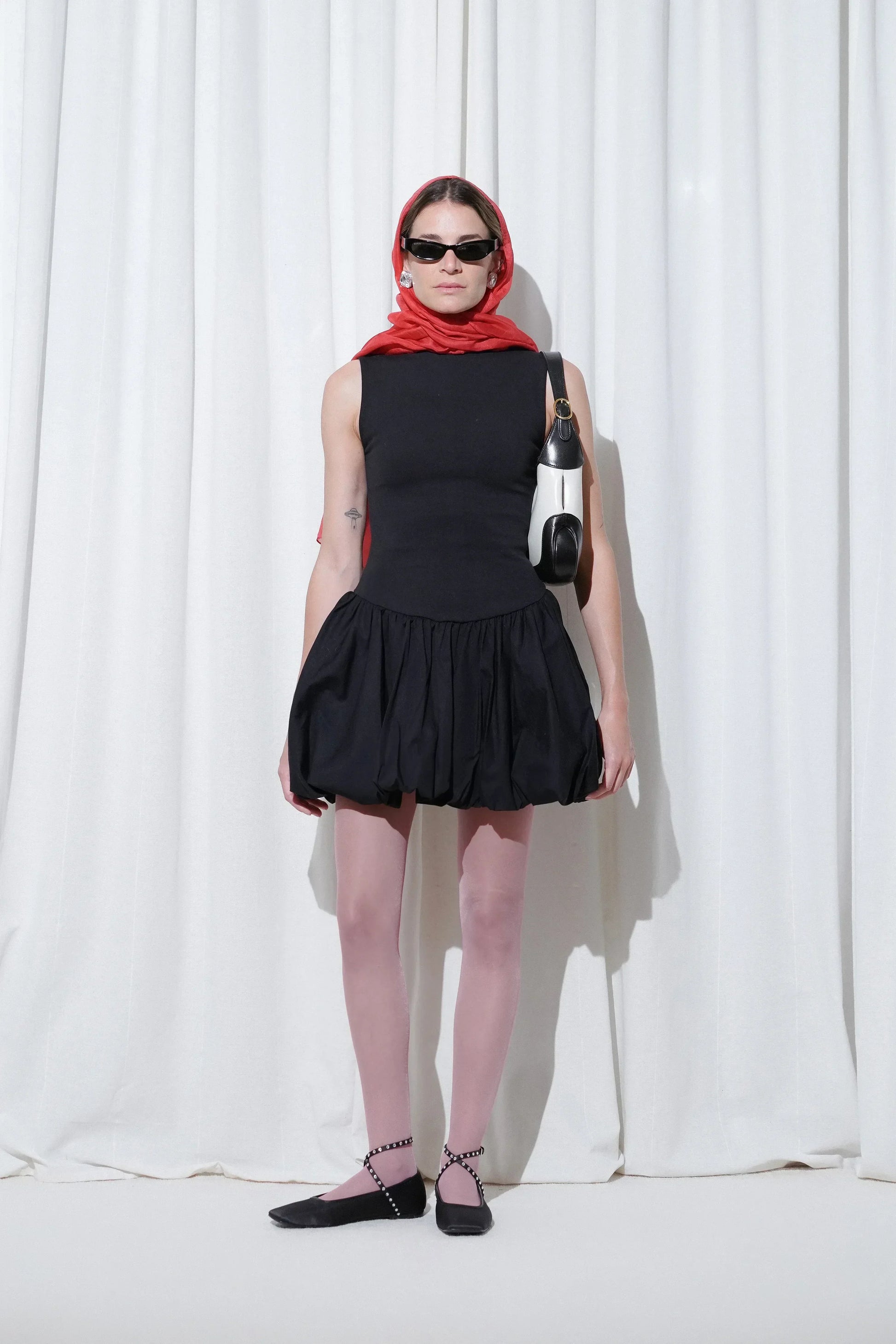 Model in a date outfit with black mini dress, red headscarf, EDLA Galaxy Pink Tights, and EDLA Saturn Black Ballet Flats.