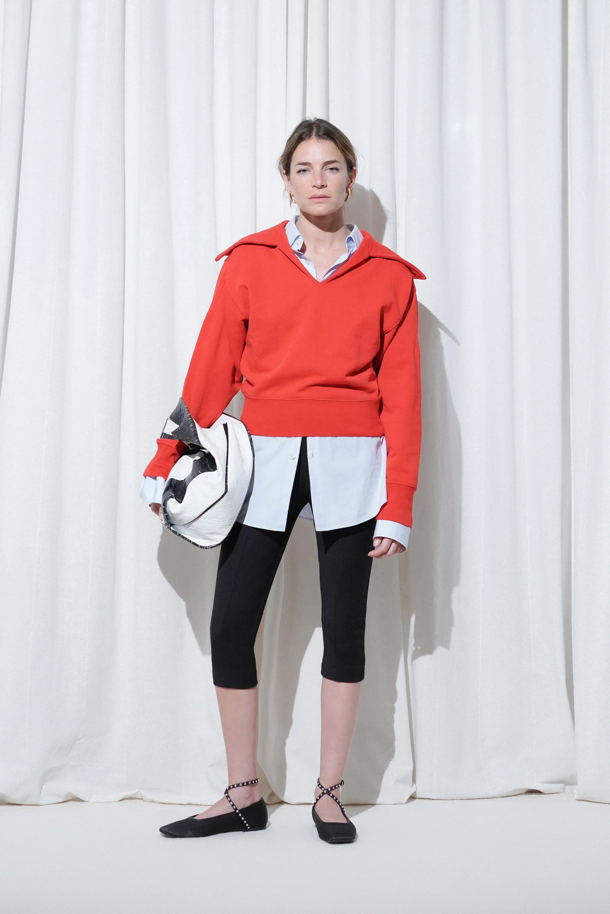 Model in a casual business outfit with red sweater, long blue shirt, black capri pants, and EDLA Saturn Black Ballet Flats.