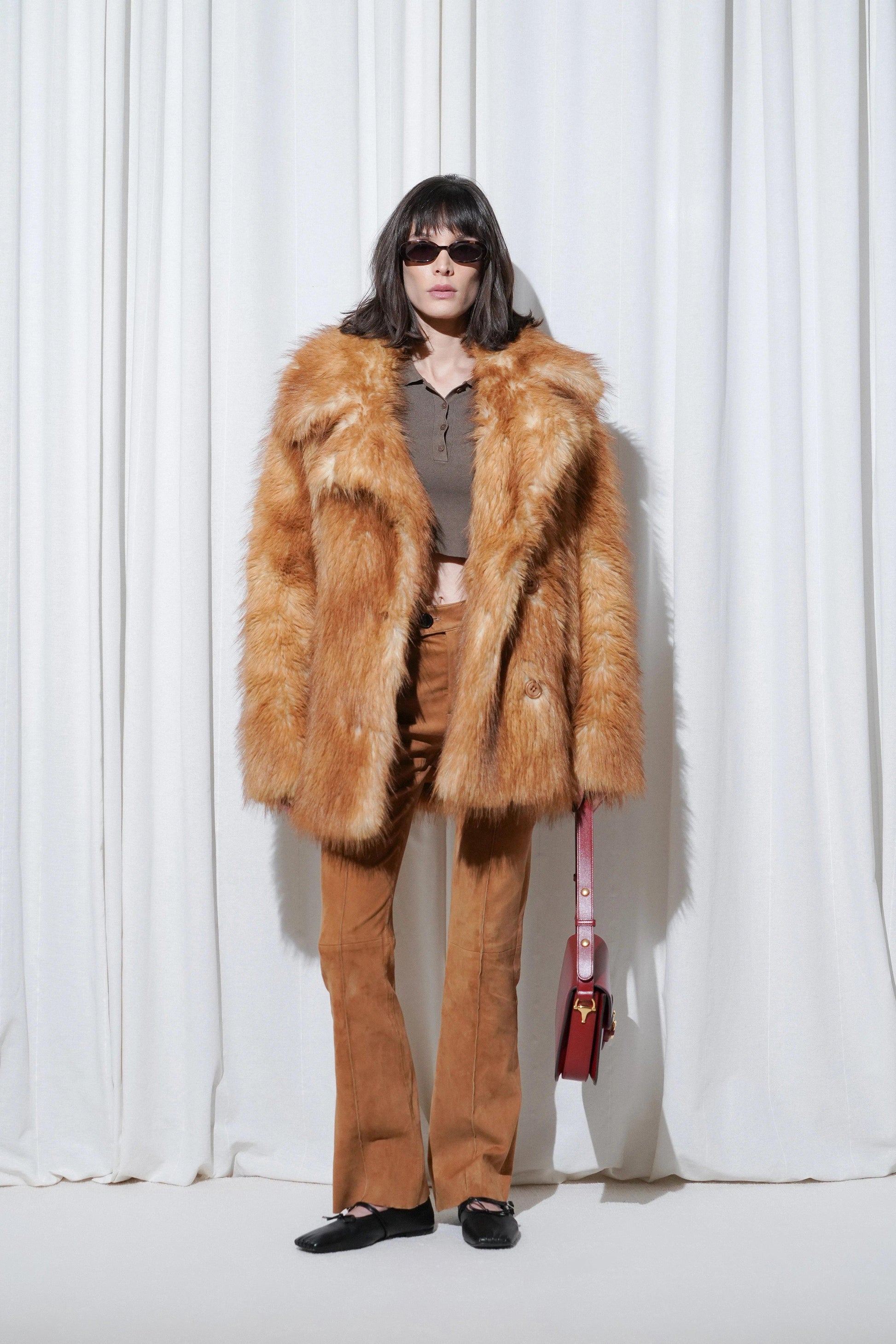 Model wearing a weekend outfit with brown faux fur coat, suede pants, and EDLA Mars Black Ballet Flats.