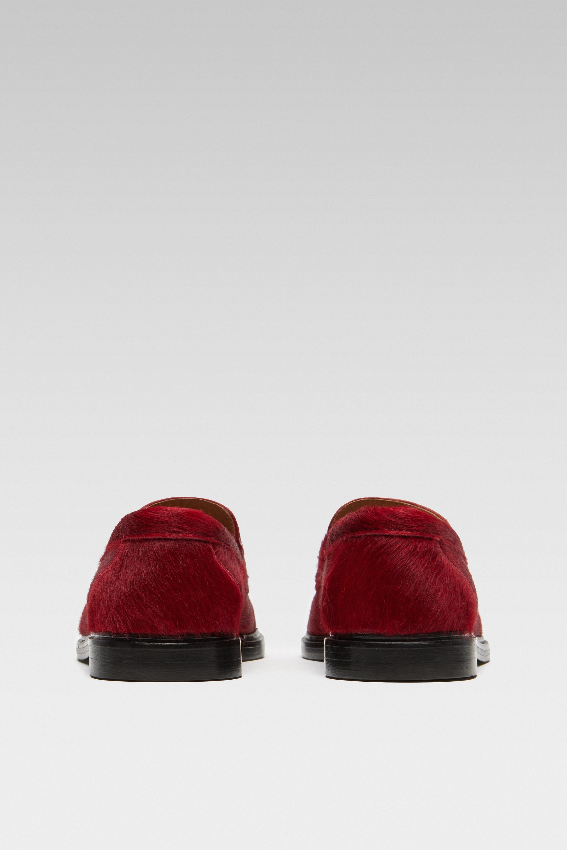Back view of EDLA Jupiter red loafers for women crafted from calf hair.