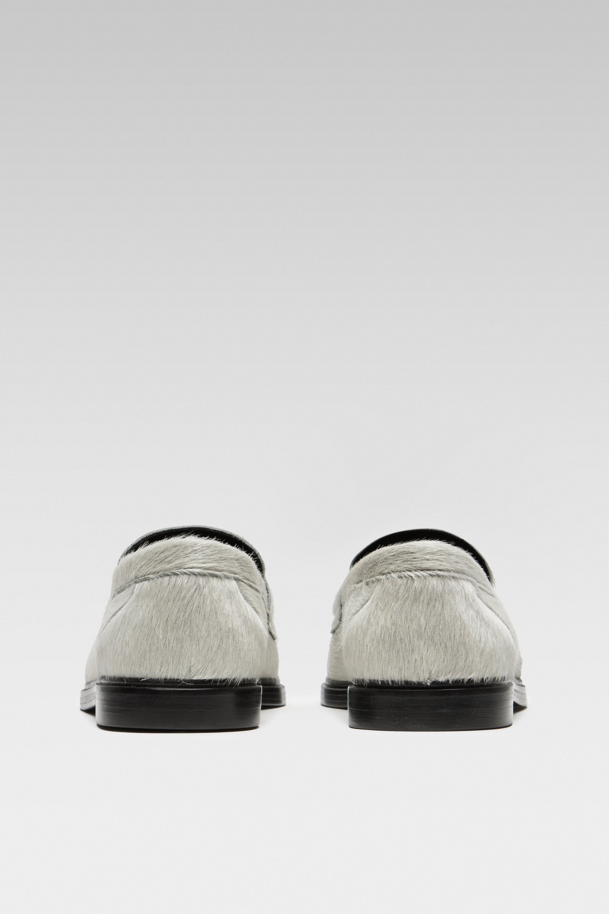 Back view of EDLA Jupiter white loafers for women crafted from calf hair.