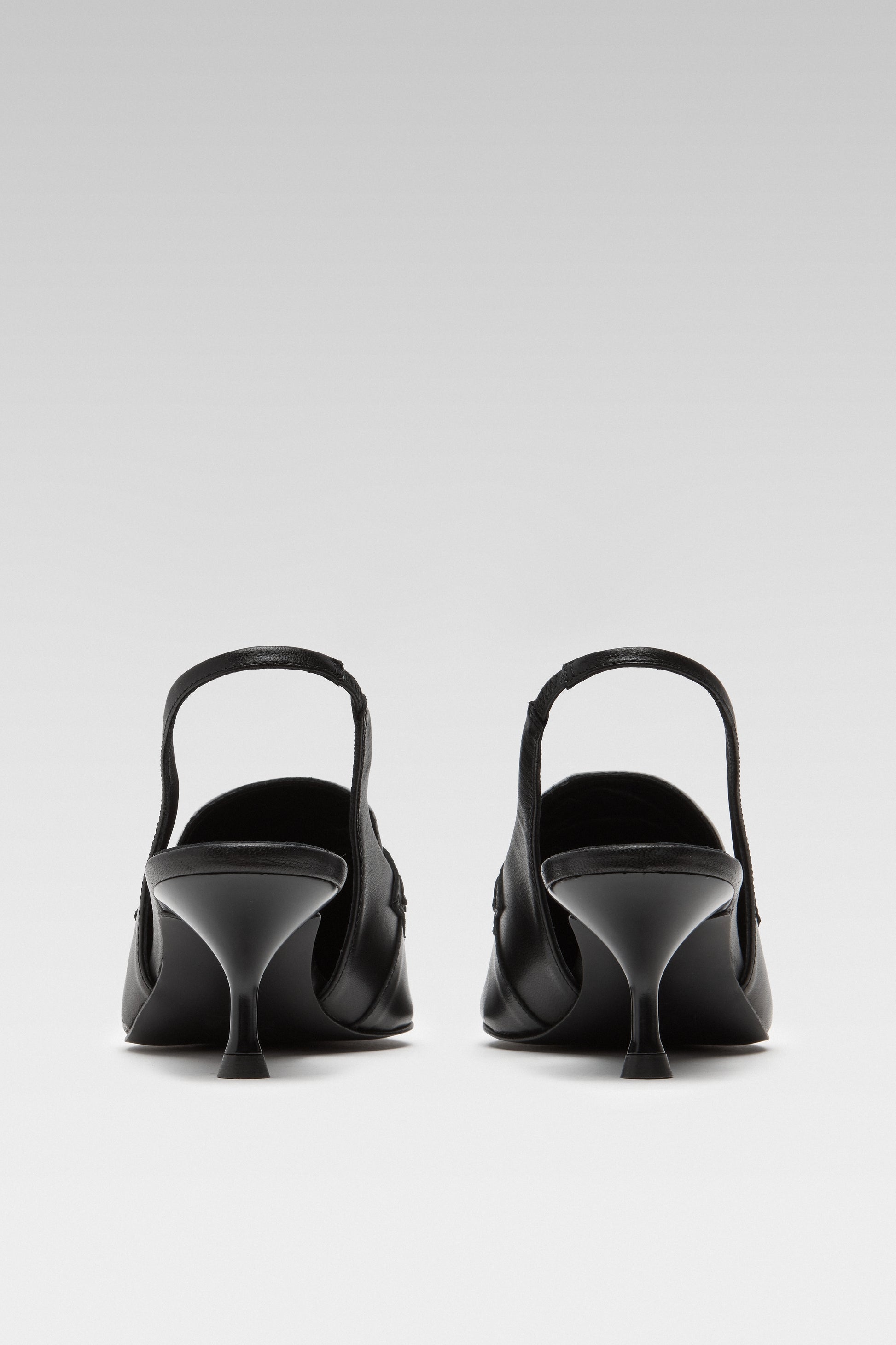 Back view of EDLA Uranus black-and-white slingback kitten heels made from leather.