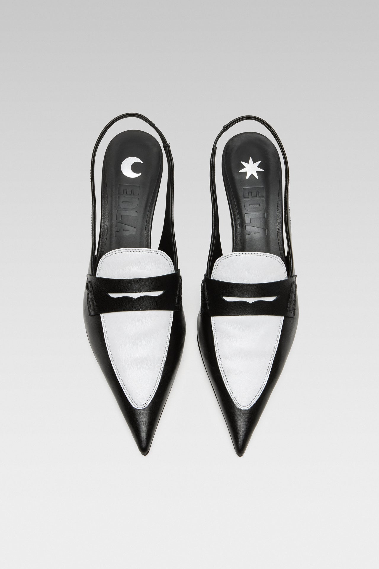 Side view of EDLA Uranus black-and-white slingback kitten heels made from leather and designed with a pointed toe and penny loafer-style front.