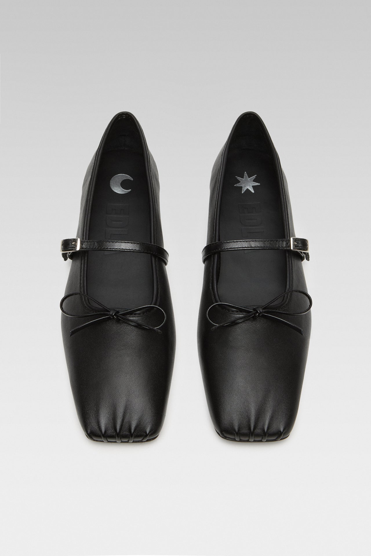 Side view of EDLA Mars black ballet flats crafted from leather.