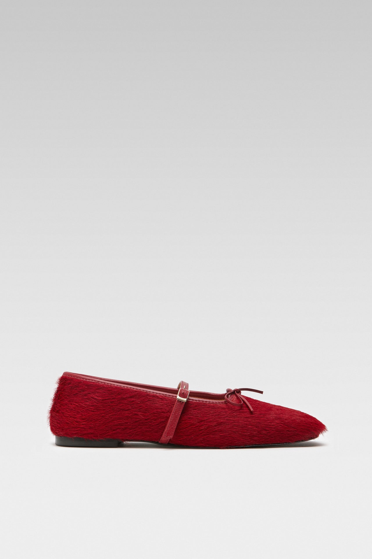 Side view of EDLA Mars red mary jane flats crafted from calf hair.