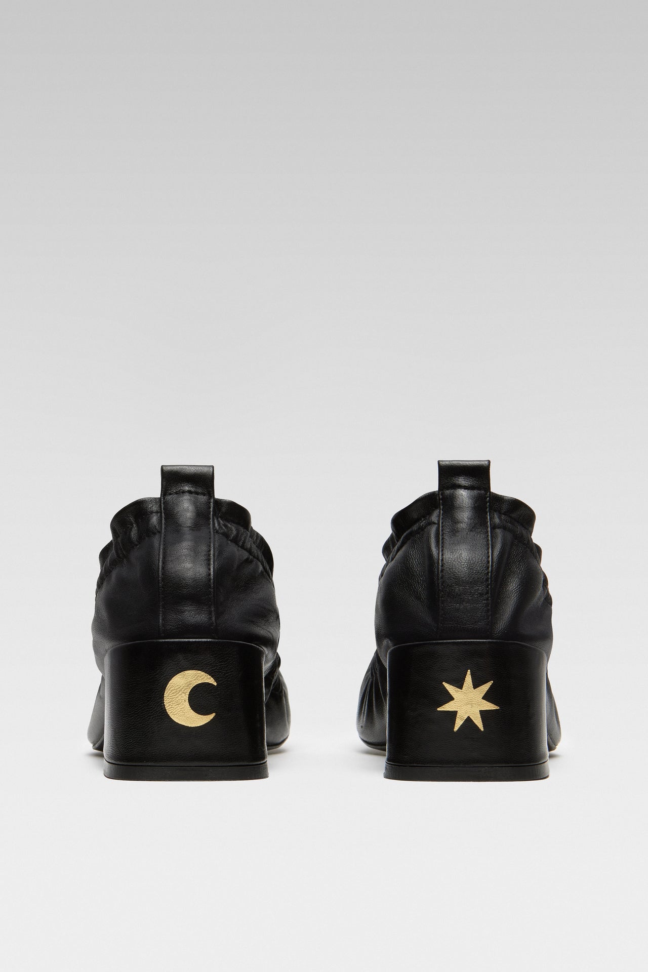 Side view of EDLA Mercury black kitten heels crafted from leather with a block heel and elastic ruched band.