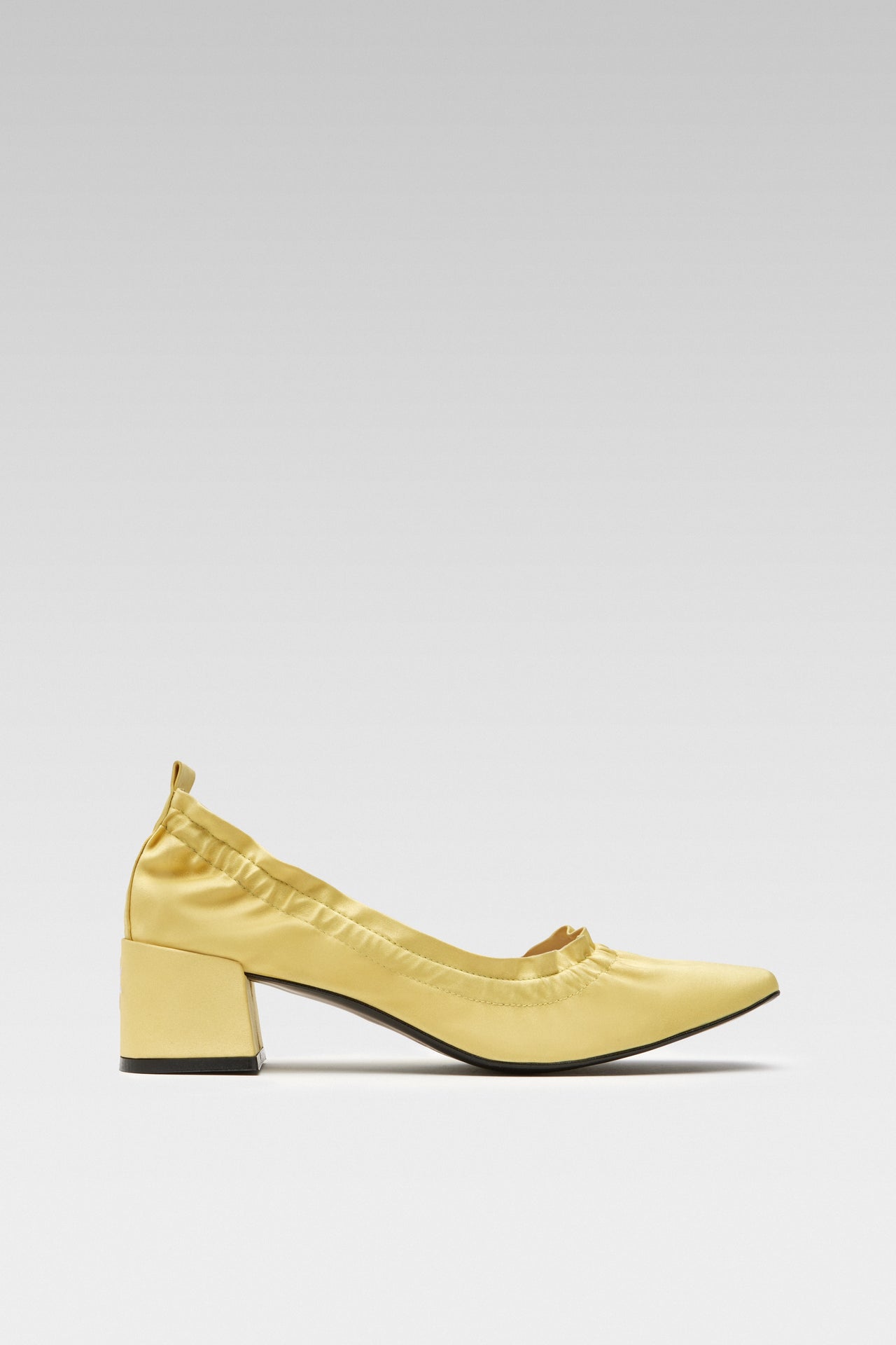 Side view of EDLA Mercury yellow kitten heels crafted from stain with a block heel and elastic ruched band.