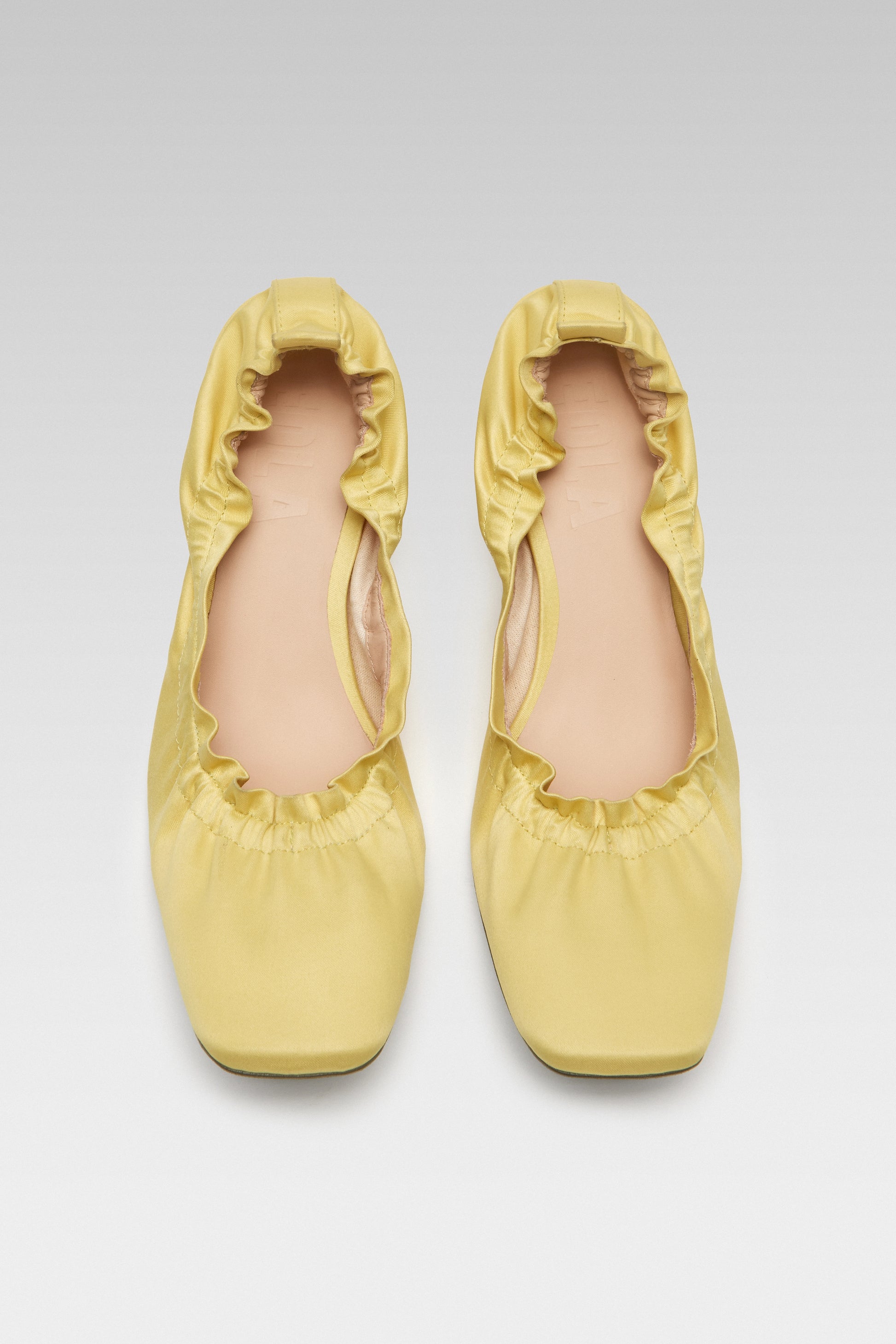 Top view of EDLA Mercury yellow kitten heels crafted from satin with a squared toe and elastic ruched band.