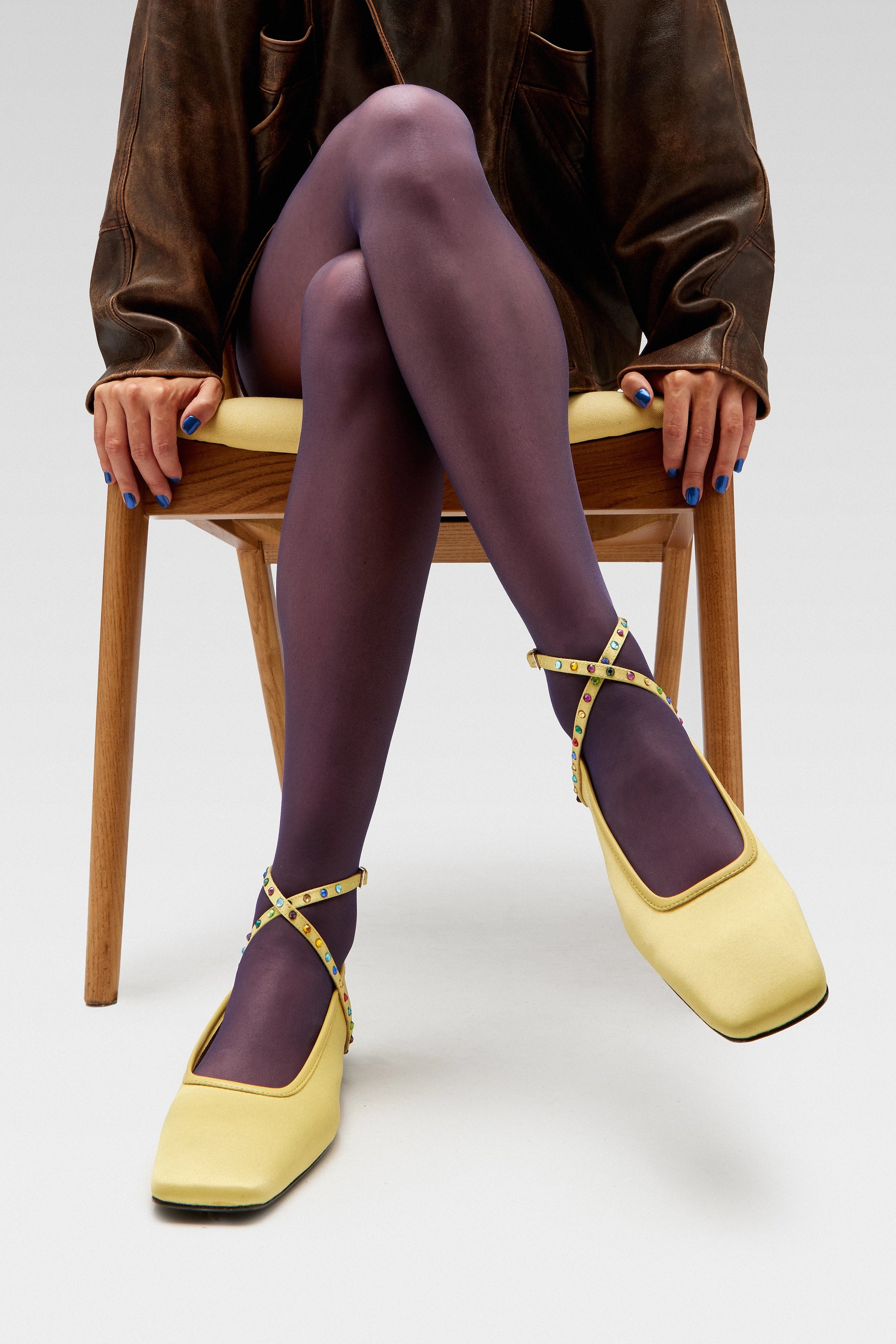 Model wearing EDLA Saturn yellow ballet flats with EDLA Galaxy purple sheer tights.