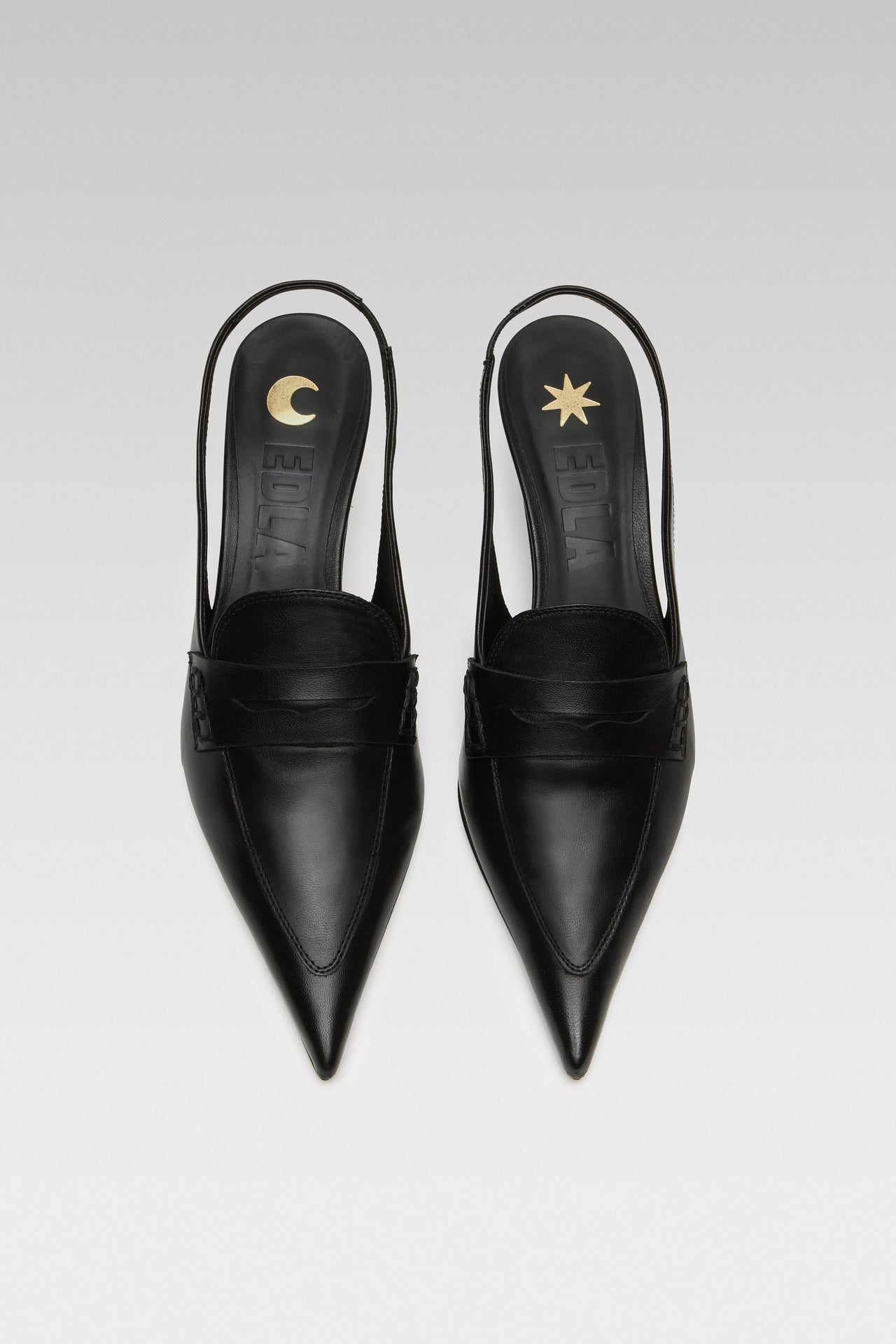 Side view of EDLA Uranus black slingback kitten heels made from leather and designed with a pointed toe and penny loafer-style front.