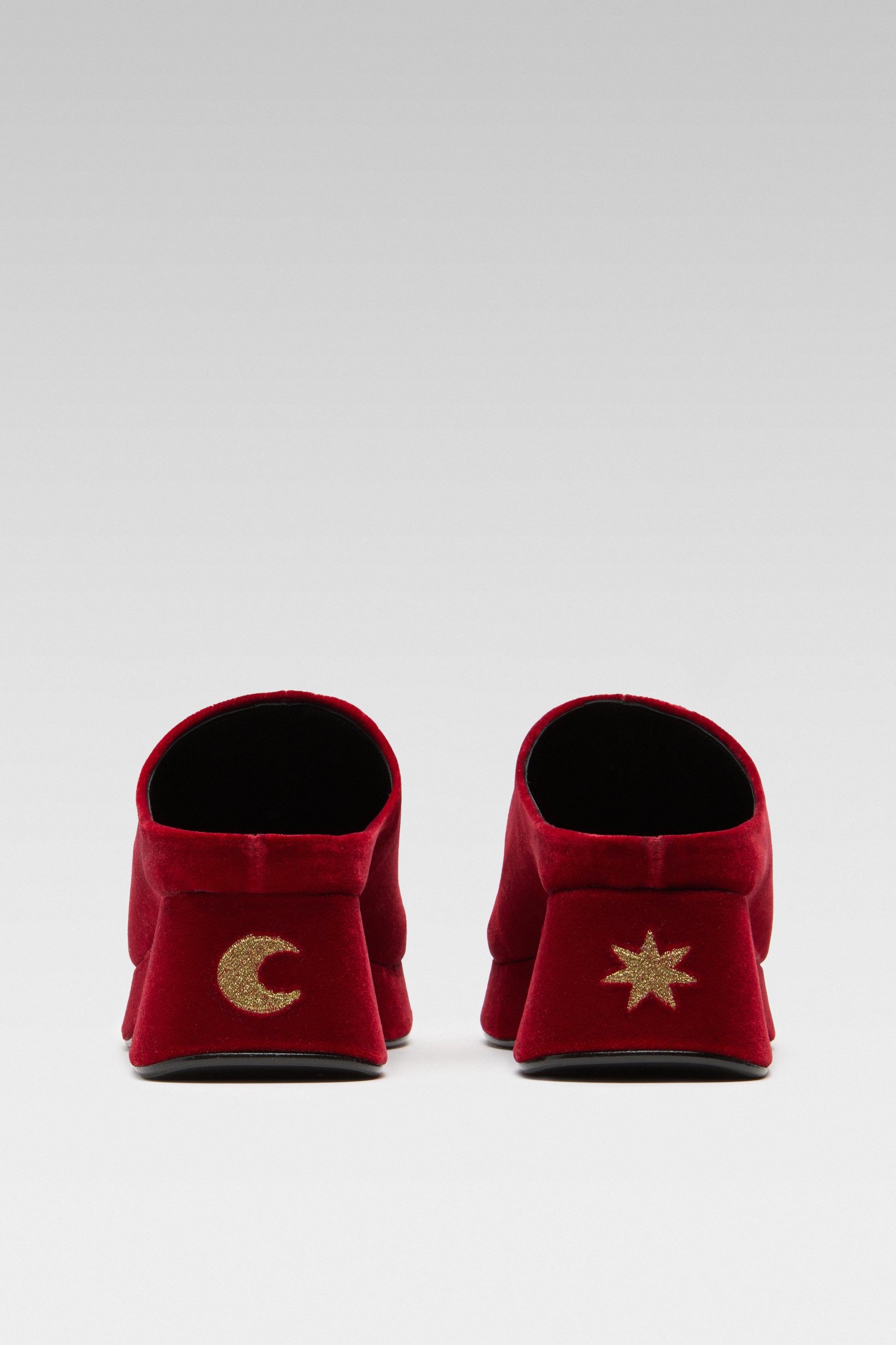 Back view of EDLA Venus red mules for women crafted from velvet with star and moon gold symbols at the back of heel.